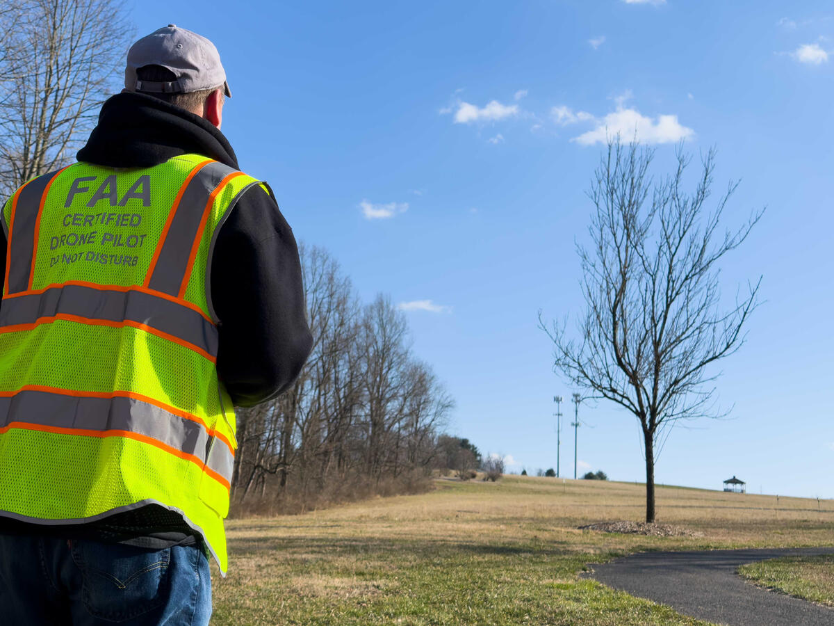 FAA-certified drone pilot in a safety vest